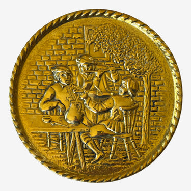 Vintage embossed brass wall plate featuring a group of musicians