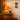 Nostalgic interior with a lamp, plant, and decor on a wall.