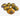 Six decorative painted eggs with a yellow, blue, and black marbled pattern arranged on a white desk.