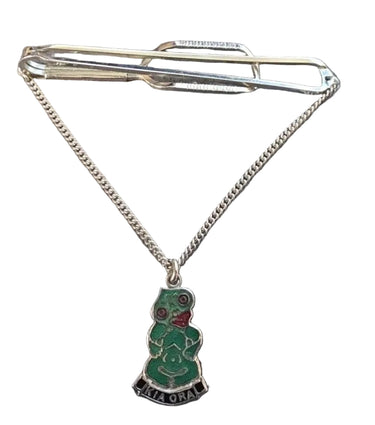 Vintage silver-tone Kia Ora tie bar with green enamel tiki charm and suspended silver chain