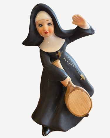 Vintage ceramic nun playing tennis figurine in black and white habit with tennis racket, marked C7128
