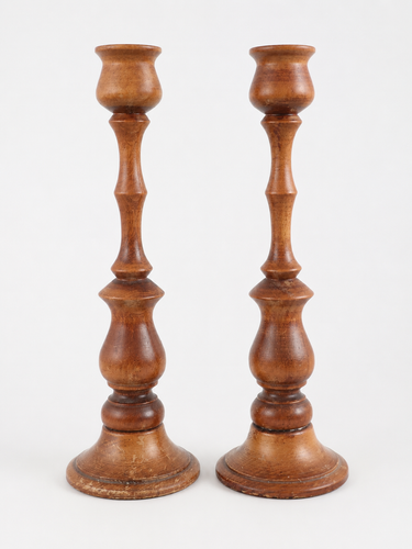 Pair of vintage turned wooden candlesticks with warm brown timber finish.