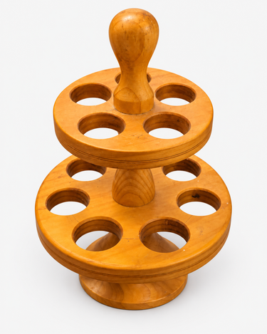 Vintage wooden two-tier egg holder on a clean neutral background