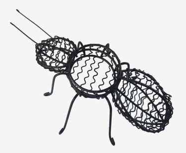 Whimsical black metal ant planter and tealight holder on a white background