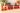 Vintage wooden pull-along toy train with red wheels carrying painted wooden soldiers on two wagons