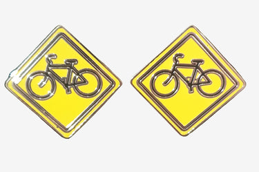 Two square yellow and black enamel cufflinks with silvertone metal, featuring a bicycle design.