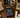 A black Casio calculator sits on a wooden desk surrounded by retro-themed props including a beige rotary phone, a vintage Commodore computer, a coffee mug reading 'I <heart> 80s', books, and a floppy disk.