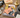 A vintage illustrated magazine titled "The Dick Tracy Casework" lies on a wooden desk surrounded by detective-themed props including a camera, magnifying glass, fingerprint cards, badge, gloves, lamp, hat, and case files.