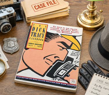 A vintage illustrated magazine titled "The Dick Tracy Casework" lies on a wooden desk surrounded by detective-themed props including a camera, magnifying glass, fingerprint cards, badge, gloves, lamp, hat, and case files.