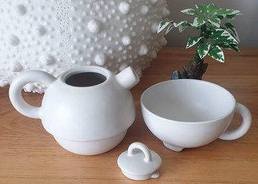 Vintage Broste Copenhagen stacking teapot and cup in off-white ceramic, photographed on a clean studio background, Planet Retro NZ.