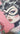 Illustration of a stylized woman's face with tattoos and makeup on a pink background.  Catwoman Planet Retro NZ.