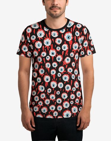Man wearing a t-shirt with a unique eye pattern design on a plain background