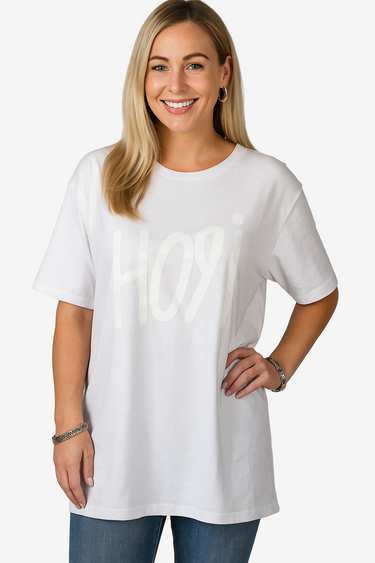 Woman wearing a white t-shirt with text on a plain background