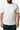 Person wearing a white t-shirt with 'HORI' printed on it against a neutral background