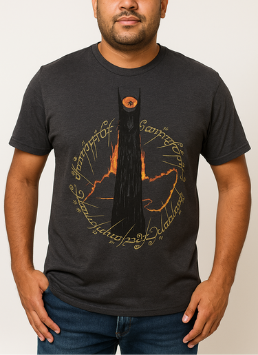 Man wearing a black t-shirt with a unique design on a plain background