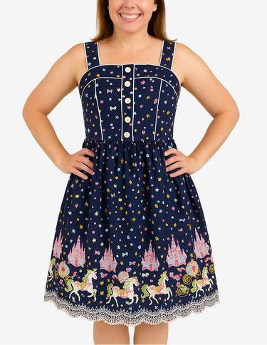 Woman wearing a navy blue dress with fairy tale-themed print on a beige background