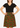 Woman wearing a black top and a skirt with red and green pattern on a beige background