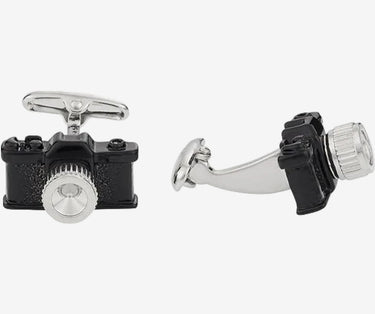 Camera-shaped cufflinks on a white background