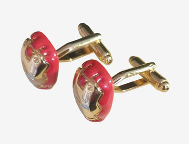 Red and gold cufflinks on a white background
