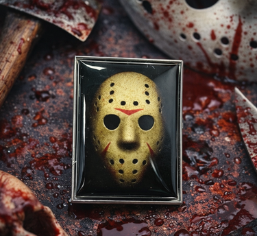 Horror-themed Jason Voorhees Friday the 13th brooch with a bloody background