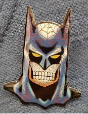 Colorful bat mask with a superhero design on a textured gray background