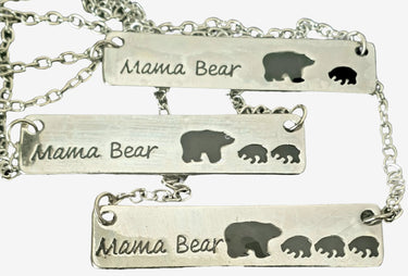 Silver 'Mama Bear' necklace with bear illustrations on a white background