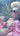 Lady in a colourful outfit sitting in a garden with Mount Taranaki, a UFO, and pink smoke in the background.  Planet Retro NZ.