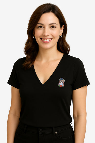 Woman wearing a black V-neck t-shirt with a small graphic on a beige background