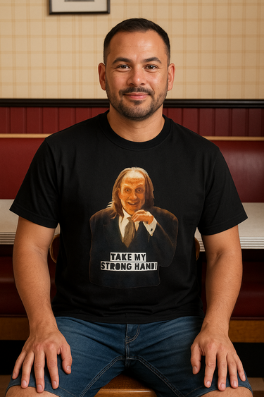 Man wearing a black t-shirt with a graphic design and text, sitting in a booth.