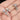 Silver hammer-shaped cufflinks on a hand