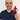 Man holding a red action figure against a white background