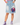 Model wearing Planet Retro Stranger Things Vecna upcycled denim button skirt with pink shirt and purple high-top trainers – AI styled image