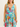 Woman wearing a colorful floral dress against a plain background