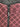Close-up of a pink and black patterned fabric with a zipper, featuring the brand 'CUE'. Planet retro NZ