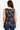 Woman wearing a Planet Retro tank top with angel and 'Don't Blink' print against a plain background