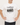Man wearing a white t-shirt with a graphic design and text on a plain background