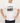 Man wearing a white t-shirt with a graphic design and text on a plain background