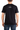 Person wearing a black t-shirt with a logo on the back against a white background