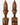 Two carved wooden bust sculptures with tall headdresses and stylized faces, shown side by side on a light gray background.
