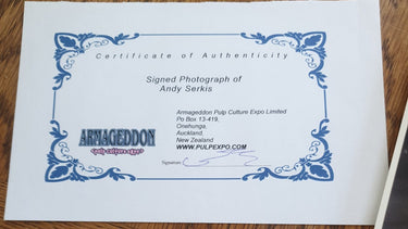 Certificate of Authenticity for a signed photograph on a wooden surface