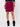 Augustine pink and black geometric tube skirt with ruched side detail, styled with black top and boots