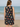 Woman wearing a sleeveless dress with heart patterns on a beach