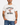 A man modeling a white graphic t-shirt with 'DENVER BEARS' and a cartoon bear printed on the front, paired with blue jeans and black sneakers, against a plain white background.