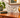 AI styled lifestyle image of clear glass horse figurine displayed on a mid-century wooden sideboard