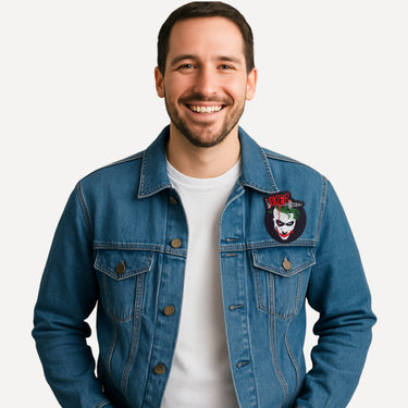 Man wearing a blue denim jacket with a patch on a white background