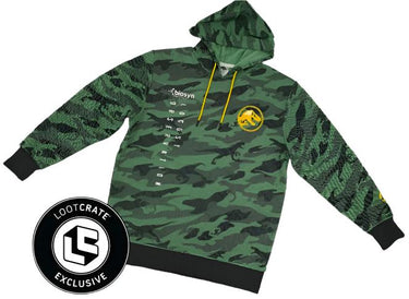 Jurassic World Dominion Biosyn Camo Hoodie with dinosaur camouflage print, long sleeves, and hood. Featuring yellow drawstrings and green brand patch on the sleeve.