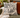 Lord and Lady Skullington black toile cushion cover styled on olive sofa with rust cushion and cream throw