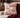 Lord and Lady Skullington Wine toile cushion cover styled on an upholstered chair with burgundy velvet, knit throw and vintage books