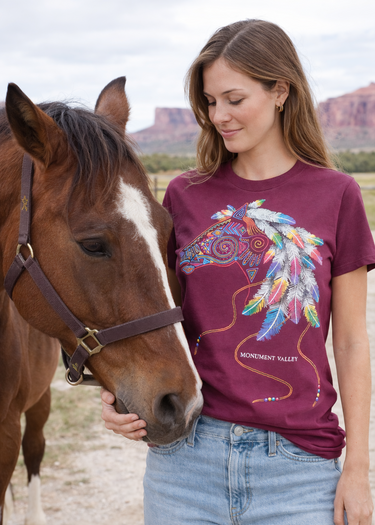 Monument Valley horse graphic T-shirt with colourful feather design on burgundy cotton