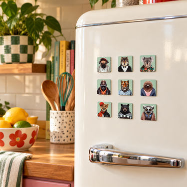 Nine preppy animal fridge magnets displayed on a cream retro refrigerator in a colourful vintage-style kitchen